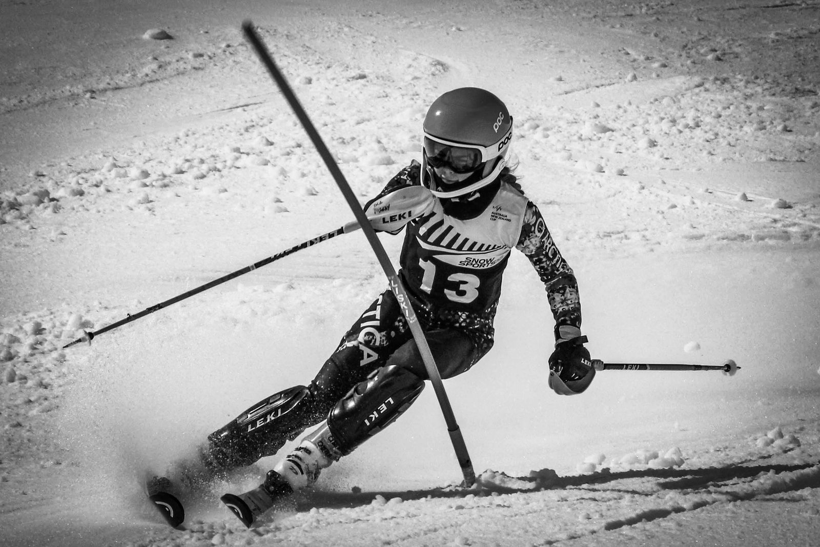 Black and white shot of Isla railing a turn in bib 13